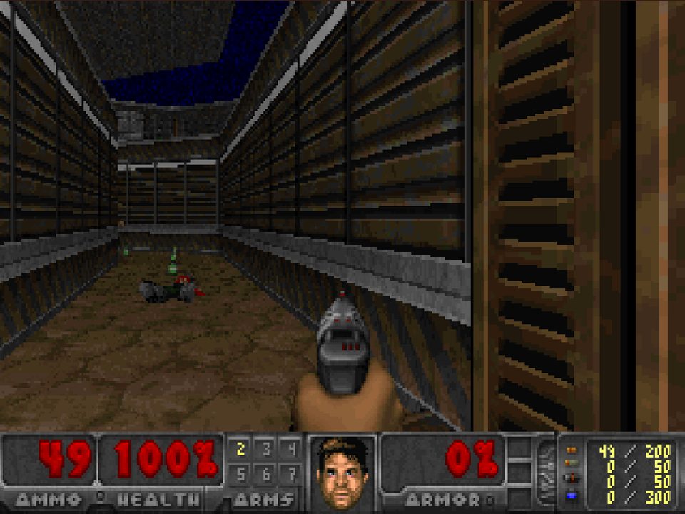 Last Marine Standing: a pistol aimed down a stone corridor above the classic health, ammo and armor status bar